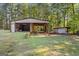 Detached workshop with a covered shelter and an additional smaller shed at 125 Laney Ct, Mcdonough, GA 30252