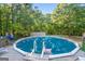 Above ground pool with wooden deck and access from the backyard at 125 Laney Ct, Mcdonough, GA 30252
