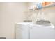 Laundry room with washer, dryer, and shelving at 3352 Se Westover Way, Conyers, GA 30013