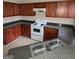 Kitchen with dark wood cabinets and granite countertops at 2290 Nicole Dr, Hampton, GA 30228