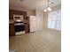 Kitchen features wood cabinets, white appliances, and a breakfast area at 2103 Grove Way, Hampton, GA 30228