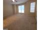 Large bedroom with carpet and two windows at 2103 Grove Way, Hampton, GA 30228