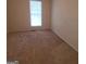 Simple bedroom with carpeted floor and a window at 2103 Grove Way, Hampton, GA 30228