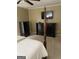 Spacious bedroom with a large bed, dresser, and carpet flooring at 4850 Lehigh Dr, Douglasville, GA 30135