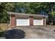 Two-car detached brick garage with white doors at 4850 Lehigh Dr, Douglasville, GA 30135