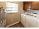Functional laundry area with a window and upper cabinets at 4850 Lehigh Dr, Douglasville, GA 30135
