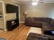 Spacious living room featuring a large sectional sofa and hardwood floors at 4850 Lehigh Dr, Douglasville, GA 30135