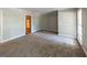 Spacious living room with neutral decor and view to kitchen at 4850 Lehigh Dr, Douglasville, GA 30135
