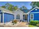 Close-up of the home's entrance, showcasing the white brick, blue siding, and welcoming front door at 2037 Emily Dr, Social Circle, GA 30025