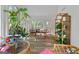 Bright sunroom featuring hardwood floors, wicker furniture, and lush greenery at 270 Emerald Lake Dr, Fayetteville, GA 30215