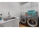 Laundry room with washer, dryer, cabinets, and a sink at 270 Emerald Lake Dr, Fayetteville, GA 30215