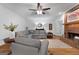 Gathering room featuring a brick fireplace, hardwood floors, and comfortable seating area at 270 Emerald Lake Dr, Fayetteville, GA 30215