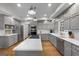 Modern kitchen featuring gray cabinets, stainless steel appliances, and a large island at 270 Emerald Lake Dr, Fayetteville, GA 30215