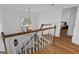 Elegant staircase with wooden railing overlooks the entryway at 270 Emerald Lake Dr, Fayetteville, GA 30215