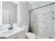 Bathroom with marble shower, gray vanity, and modern fixtures at 2844 Riverchess Sw Ct, Atlanta, GA 30331