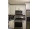 Modern kitchen with stainless steel appliances and white cabinets at 2734 Laurel View Dr, Snellville, GA 30039