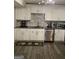 Updated kitchen featuring white cabinets, gray countertops, and LVP flooring at 2734 Laurel View Dr, Snellville, GA 30039