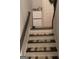 Stairs with dark wood railings and neutral carpeting at 2734 Laurel View Dr, Snellville, GA 30039