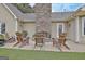 Stone fireplace and wooden chairs on a patio at 676 Mcbride Rd, Fayetteville, GA 30215