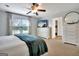 Bedroom with white dresser, TV, and ceiling fan at 676 Mcbride Rd, Fayetteville, GA 30215