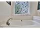 Bathroom featuring garden tub and decorative window at 676 Mcbride Rd, Fayetteville, GA 30215