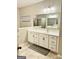 Elegant bathroom with double vanity, large mirror, and tile flooring at 4020 Red Canoe Bnd, Lilburn, GA 30047