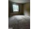 Well-lit bedroom featuring carpeted floors and a window at 1505 Camelot Dr, College Park, GA 30349