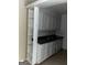 Galley kitchen with white cabinets and built-in shelving at 1505 Camelot Dr, College Park, GA 30349