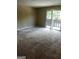 Bright living room featuring carpet and sliding glass doors to balcony at 1505 Camelot Dr, College Park, GA 30349