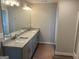 Double vanity bathroom with granite countertops and modern lighting at 2990 Fareed St, Douglasville, GA 30135