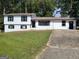 Front view of a white two-story house with black windows at 6517 Revena Dr, Morrow, GA 30260