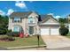 Two-story house with two-car garage and landscaping at 2206 Sugar Maple Nw Ct, Acworth, GA 30101