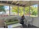Cozy screened porch with wicker furniture and green accents at 2206 Sugar Maple Nw Ct, Acworth, GA 30101
