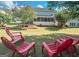 Relaxing backyard with a deck and red chairs at 2206 Sugar Maple Nw Ct, Acworth, GA 30101