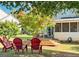 Backyard with red chairs, deck, and screened porch at 2206 Sugar Maple Nw Ct, Acworth, GA 30101