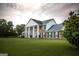 Brick house with white columns, green shutters, and a large lawn at 1530 Highway 11, Mansfield, GA 30055