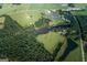 Aerial view of property with two ponds, wooded areas, and solar panels at 1530 Highway 11, Mansfield, GA 30055