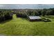 Red barn in a large green field, ideal for storage at 1530 Highway 11, Mansfield, GA 30055