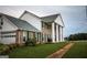 Side view of brick house with white columns, green shutters, and attached garage at 1530 Highway 11, Mansfield, GA 30055