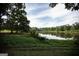 Serene pond view with lush green grass and mature trees at 1530 Highway 11, Mansfield, GA 30055