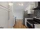 White shaker cabinets, granite counters, and stainless steel appliances at 3060 Nw Pharr Cts # 317, Atlanta, GA 30305