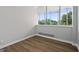Bright bedroom with wood-look floors and large window offering treetop views at 3060 Nw Pharr Cts # 317, Atlanta, GA 30305