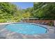 Community pool with lounge chairs and umbrellas at 3060 Nw Pharr Cts # 317, Atlanta, GA 30305
