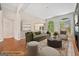 Virtually staged living room with fireplace and green sofa at 2121 Whitekirk Nw St, Kennesaw, GA 30152