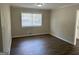 Bright living room featuring wood-look floors and a large window at 1863 Rollingwood Se Dr, Atlanta, GA 30316