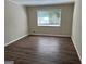 Simple bedroom with wood flooring and window at 1863 Rollingwood Se Dr, Atlanta, GA 30316
