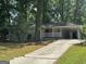 Ranch home with a long driveway and mature trees at 2360 Green Forrest Dr, Decatur, GA 30032