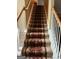 Elegant staircase with a runner carpet leading to the upper level at 1158 Folkstone Dr, Mcdonough, GA 30253
