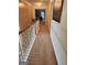 Bright hallway with neutral carpeting and access to bedrooms at 1158 Folkstone Dr, Mcdonough, GA 30253