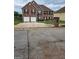 Brick house with two-car garage and landscaped yard at 1158 Folkstone Dr, Mcdonough, GA 30253